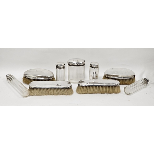 364 - Four early 20th century silver-mounted brushes and five silver-topped glass jars, comprising: a pair... 