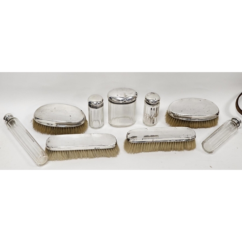 364 - Four early 20th century silver-mounted brushes and five silver-topped glass jars, comprising: a pair... 