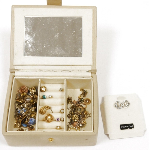 521 - Small quantity of costume jewellery to include various earrings etc. in cream leather jewellery case