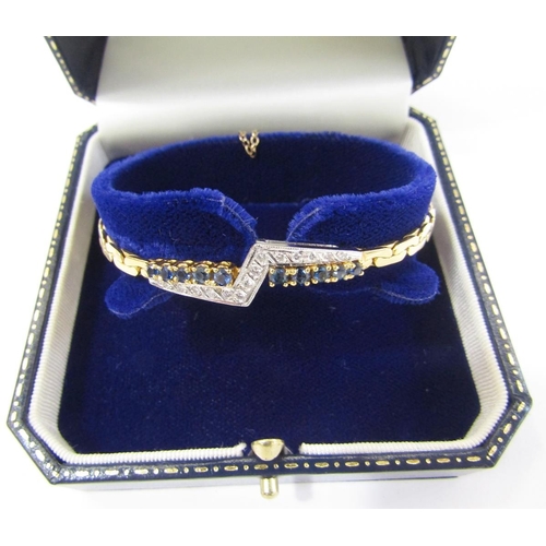 528 - 18ct gold sapphire and diamond bracelet having abstract band of diamonds flanked by 10 graduated cla... 