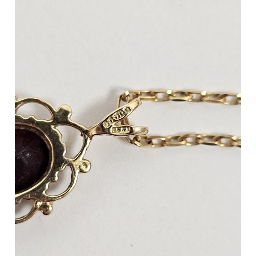 581 - 9ct gold and garnet pendant oval stone in pierced work mount on 9 carat gold oval link chain