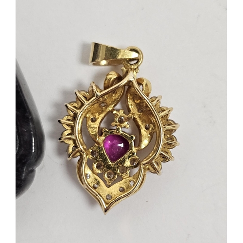 659 - Gold coloured metal, diamond and pink stone arabesque pendant centred by a pear shaped pink stone wi... 