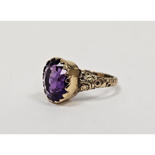 666 - Gold coloured metal and amethyst coloured stone ring set oval facet cut stone in collet setting, eng... 