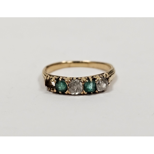 670 - Yellow metal emerald and diamond ring set two diamonds alternating with two emeralds (one diamond mi... 