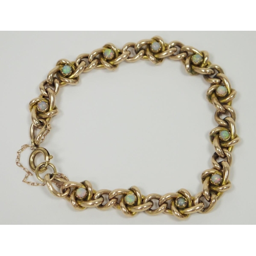 692 - Yellow metal fancy link bracelet, set with twelve claw set opals, stamped 9ct, with later yellow met... 