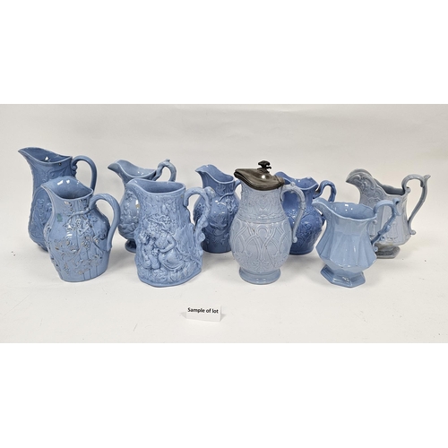 79a - Collection of approximately twenty two 19th century moulded relief jugs with a pale blue glaze