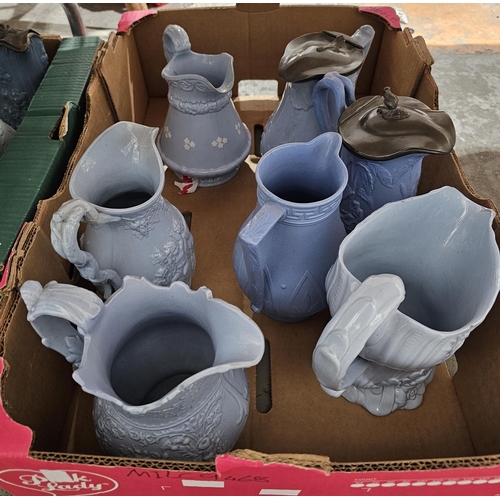 79b - Collection of approximately twenty two 19th century stoneware moulded relief jugs with pale blue gla... 