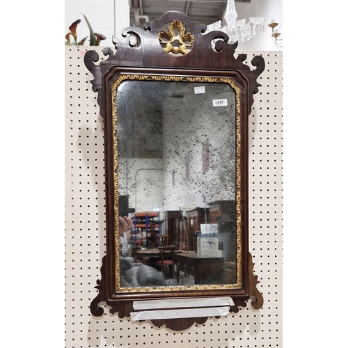 1245 - 19th century carved mahogany wall mirror, with gilt border and leaf finial, 77cm x 43cm