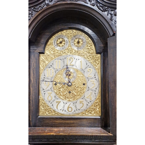 1015A - Early 20th century longcase tube chime clock of large proportions, the stained oak case heavily and ... 