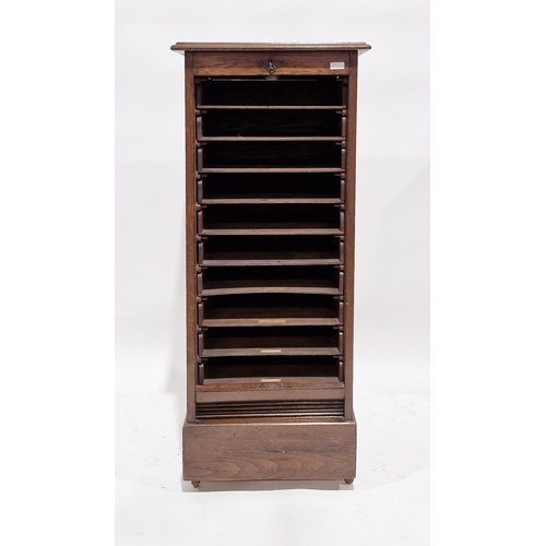 1185 - Edwardian oak stationery cabinet with drop down tambour front, opening to 10 slide out stationery co... 