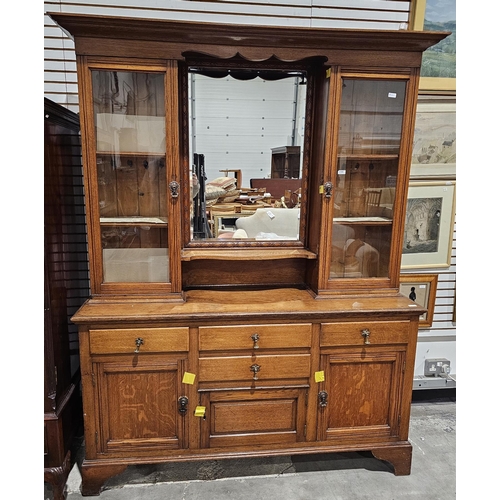 1253 - Late 19th century oak dresser, the mirrored back flanked by two glazed cupboards opening to fixed sh... 