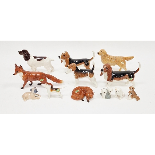 20 - Two Beswick model Bassett hounds, Beswick model fox standing and another lying and curled up, and a ... 