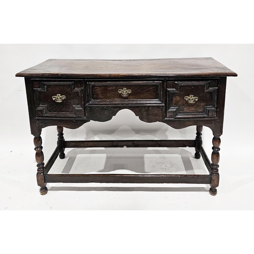 1047 - Antique oak side table, the plain top above three moulded drawers and shaped frieze raised on turned... 