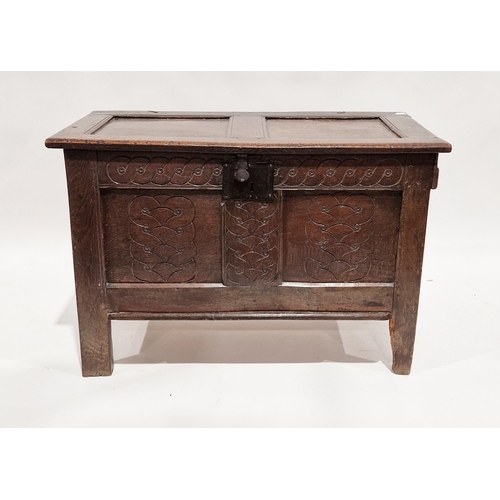 1062 - 18th century oak coffer, the hinged two panel lid opening to an empty space, the two panel front wit... 