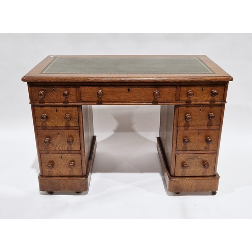 1108 - Mid Victorian oak twin-pedestal desk, the green leather inset top with thumbnail moulded edge, over ... 