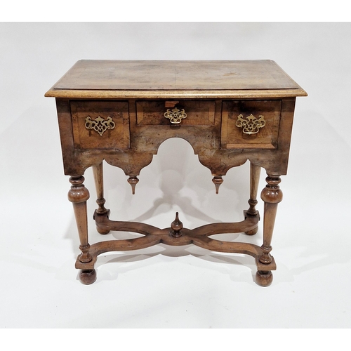 1110 - William and Mary-style walnut lowboy, the top with thumbnail moulded edge, above an arrangement of t... 