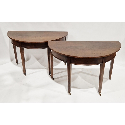 1130 - Pair of early 19th century oak demi-lune side tables, the plain friezes with moulded edges and raise... 