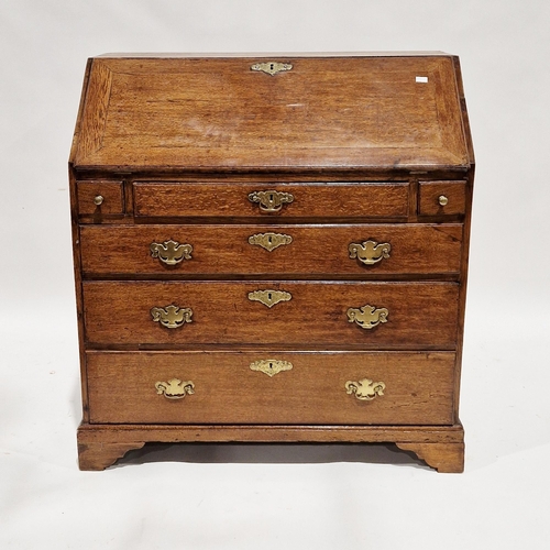 1131 - George III oak bureau, the sloping fall front opening to a fitted interior, with three drawers over ... 