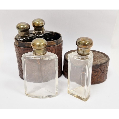 131A - Early 20th century four-bottle cologne or spirit flask set, each with silver plated screw-on caps an... 