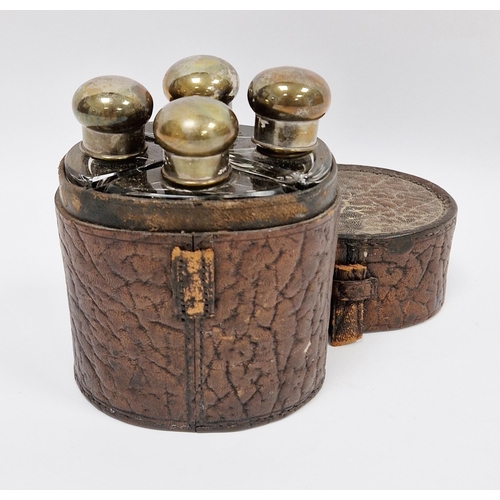 131A - Early 20th century four-bottle cologne or spirit flask set, each with silver plated screw-on caps an... 