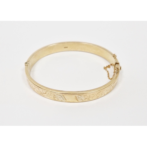 520 - 9ct gold flattened bangle with engraved decoration, 10.3g