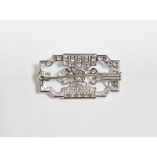 563 - Art Deco diamond white metal openwork brooch, the principal round brilliant cut diamond to centre me... 