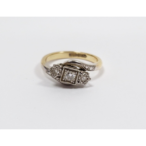 573 - 18ct yellow metal and platinum cross-over diamond ring, being illusion set with three round cut diam... 