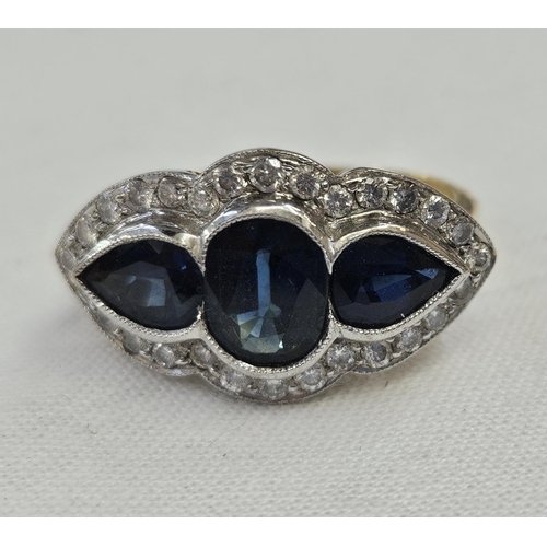 576 - 18ct gold, sapphire and diamond dress ring, the central oval sapphire 8mm x 5mm approx. flanked by p... 