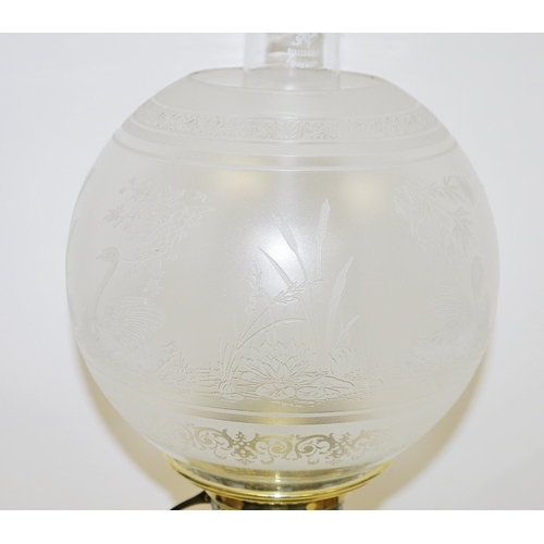 94 - Late 19th / early 20th century brass oil lamp, with opaque globular etched glass shade depicting swa... 