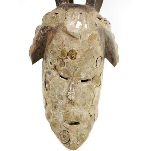 122 - African tribal wooden face mask with integrated carved head piece, possibly Igbo, the long elongated... 