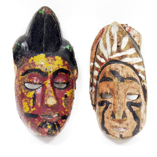 123 - Two ethnic wooden carved face masks, with polychrome decoration, 24.5cm high