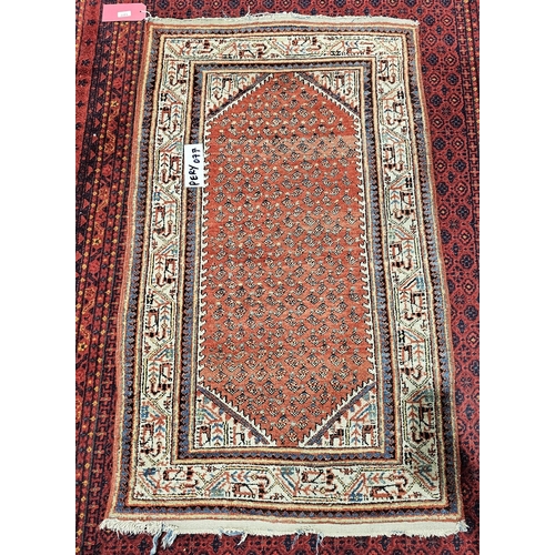 1377 - Iranian old handknotted rug with centre red background with multi-coloured designs in creams, blue, ... 