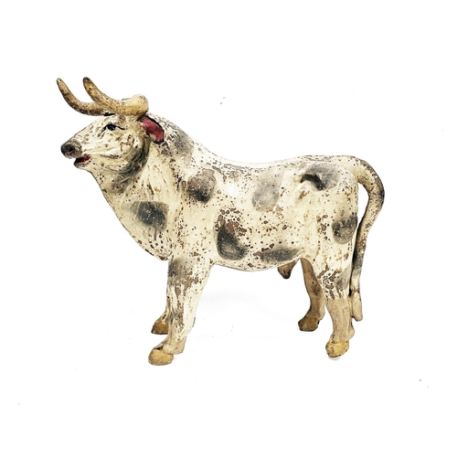 157 - South American cast metal model of a bull, with polychrome slip glazed decoration, 43cm long (damage... 