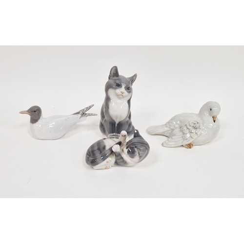 17 - Three Royal Copenhagen porcelain figures of animals including a model of a kitten playing with its t... 