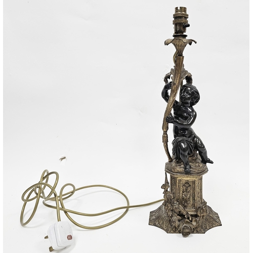 183 - Bronze figural table lamp in the form of a putto holding a foliate scrolling branch and raised on a ... 