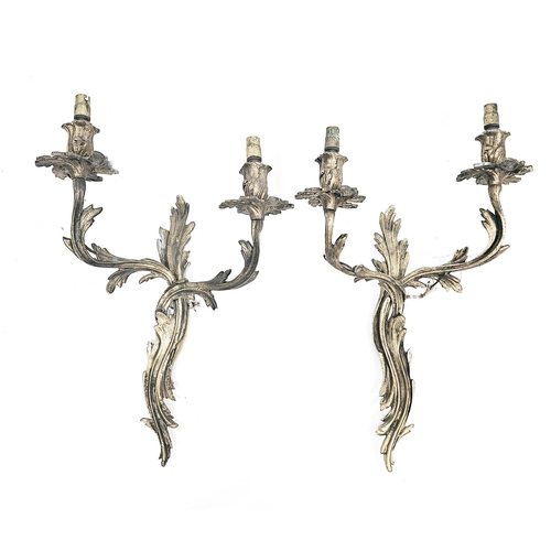 194 - Pair of gilt brass twin branch wall lights in the rococo manner with foliate scroll casting, each 49... 