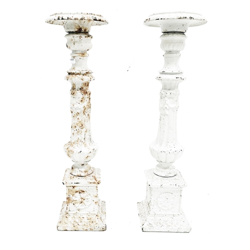 213 - Pair of cast iron candle prickets of classical column form with a white finish, 45cm high