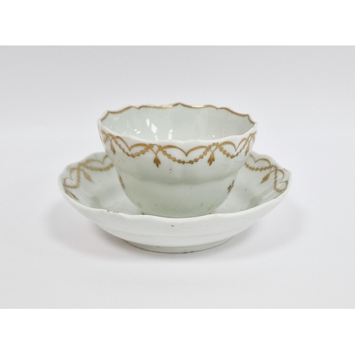 46 - Lowestoft white and gilt ogee-shaped teabowl and saucer, circa 1790, gilt with scattered sprigs belo... 