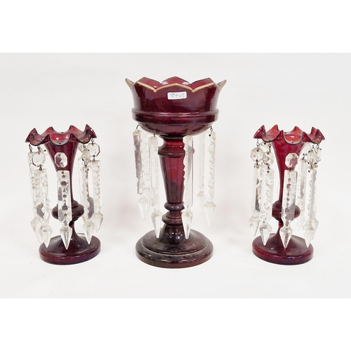 84 - Three Victorian ruby glass lustres, comprising: a pair of ruby lustres with clear cut pendant drops,... 