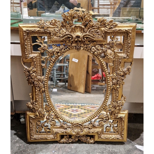 1343 - 20th century gilt framed wall mirror in the George III manner, elaborately moulded with shells, flow... 