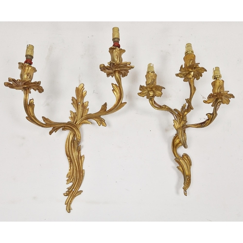 1346 - Set of four gilt metal three-branch foliate scroll wall light fittings in the rococo manner, 38cm hi... 