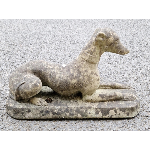 1352 - Composite stone garden statue of a recumbent greyhound, 40cm high x 68cm long