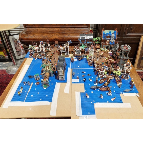 755 - A large Lego Pirate Town diorama featuring several Lego sets to include No.4194 4194 Whitecap Bay, N... 