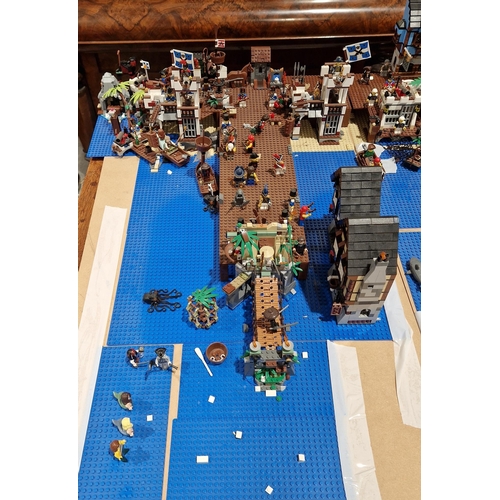 755 - A large Lego Pirate Town diorama featuring several Lego sets to include No.4194 4194 Whitecap Bay, N... 