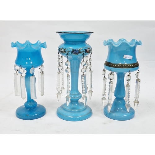 75A - An assembled garniture of three Victorian blue opaque glass lustres in two sizes, suspending cut pen... 