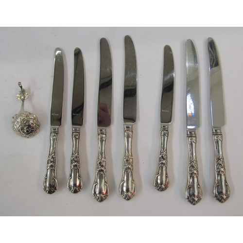 308 - Seven sterling handled knives, floral and scroll decorated, and continental silver small caddy spoon... 