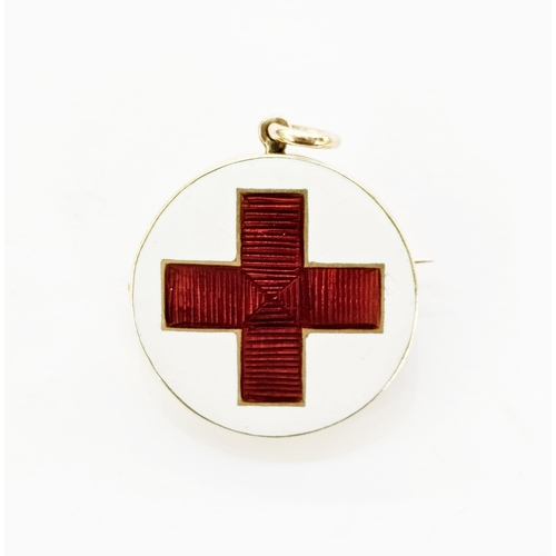 323 - Gold-coloured enamel brooch pendant of WW1 interest, the circular form enamelled with a red cross on... 