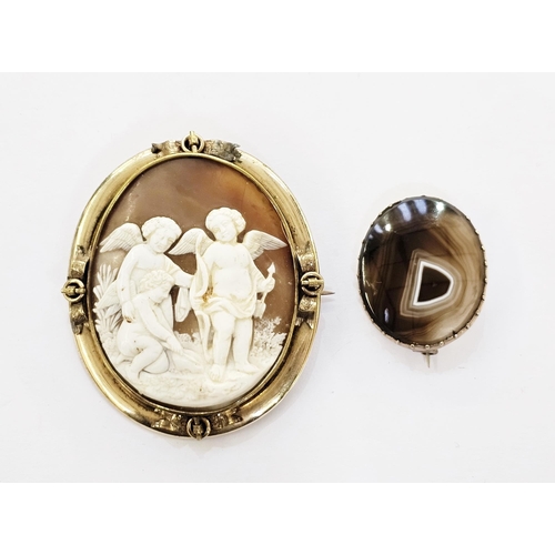 325 - Victorian gilt metal shell cameo brooch, the shell carved with a figure of Cupid, and two other wing... 