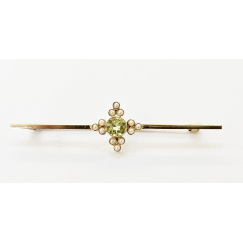 327 - Edwardian gold bar brooch set with a central circular peridot surrounded by clusters of seed pearls,... 