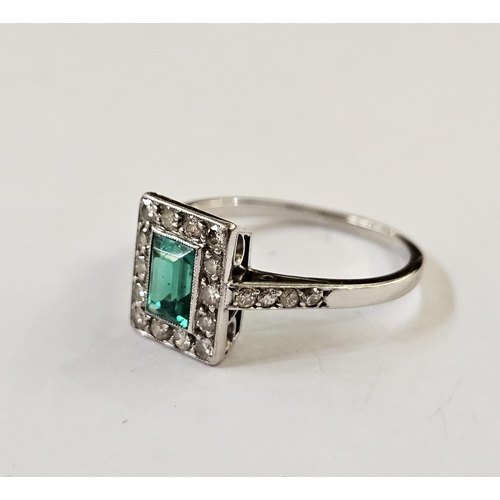 510 - White metal, diamond and emerald ring, the central cut emerald within a border of 14 brilliant cut d... 